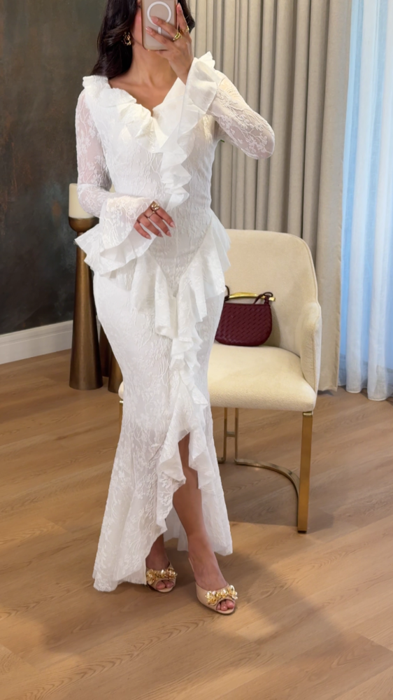 White lace dress decorated with ruffles