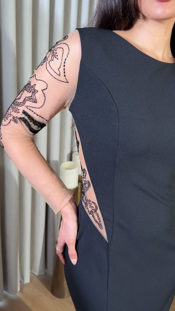 Black dress with transparent details and luxurious embroidery