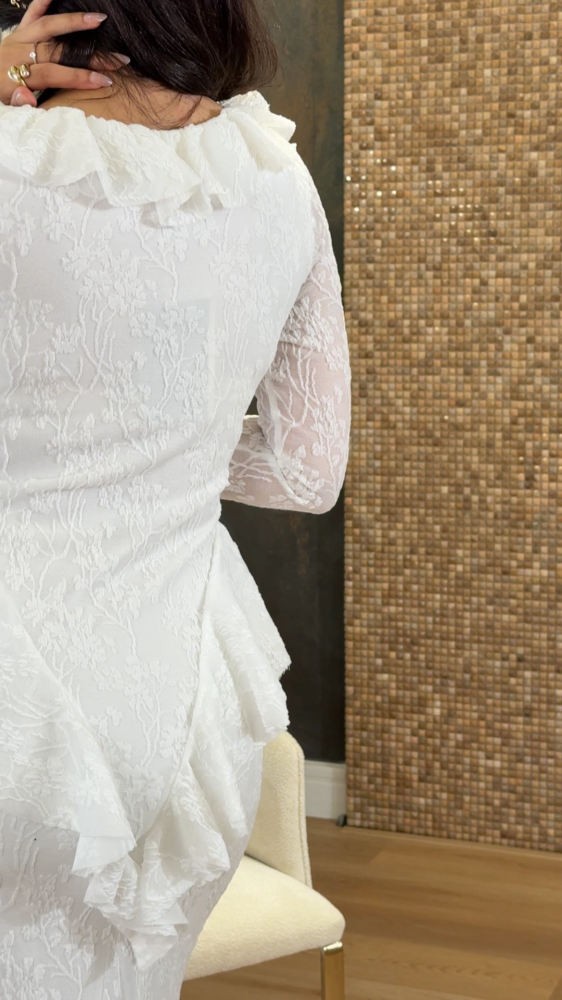 White lace dress decorated with ruffles