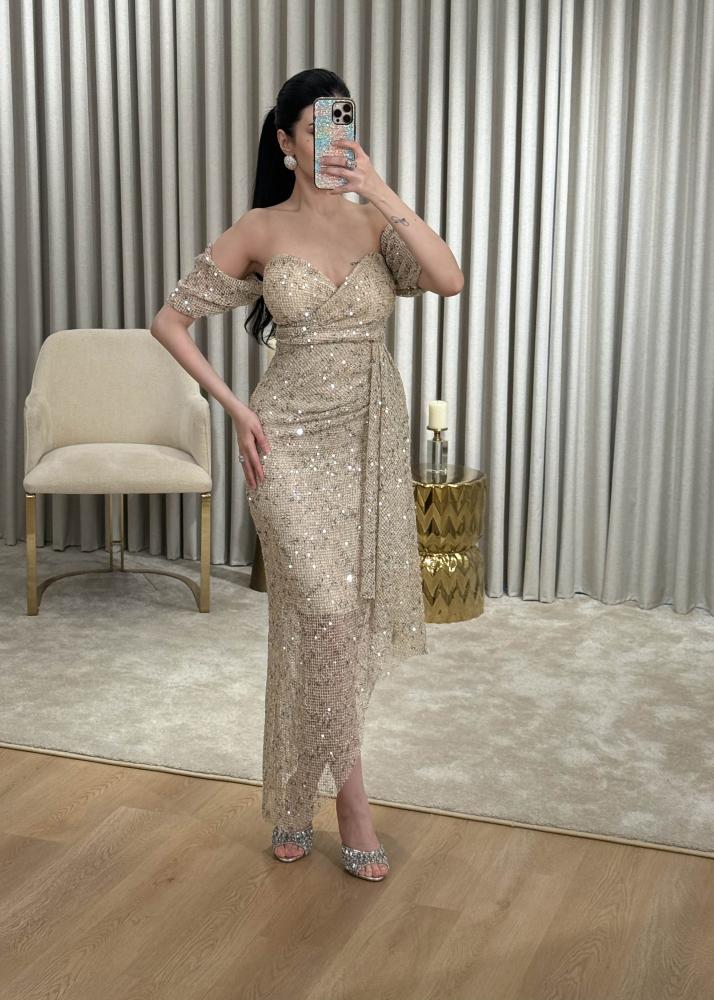 Golden evening dress in mesh fabric completely studded with crystals