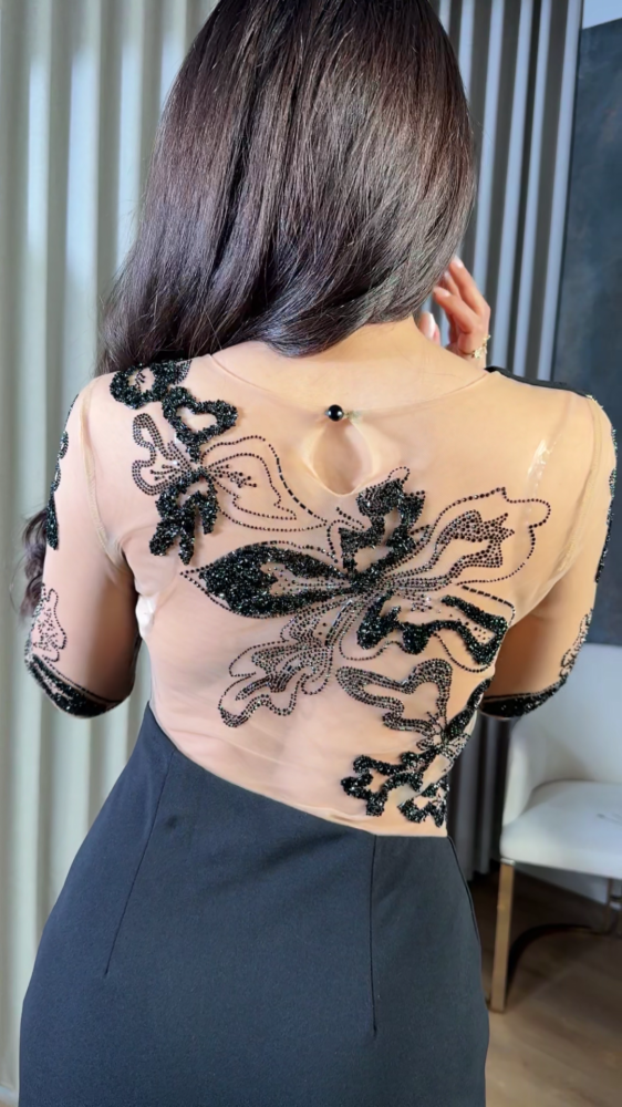 Black dress with transparent details and luxurious embroidery