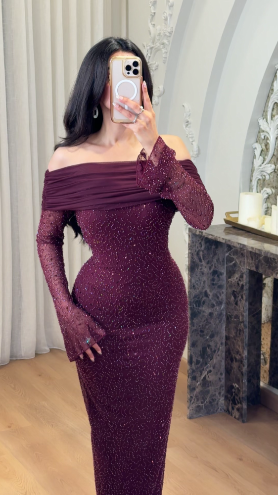 Long burgundy evening dress decorated with tulle folds