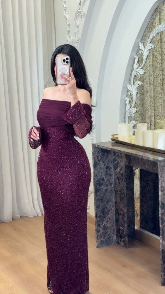 Long burgundy evening dress decorated with tulle folds